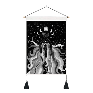 Detail of moon and girl wall tapestry featuring black and white mystical starry sky pattern