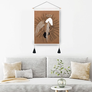 Bohemian wall tapestry with line art angel on white wall above a modern grey sofa
