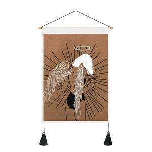 Close-up of modern tapestry featuring a winged girl illustration with black tassels