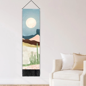 Modern Nordic tapestry featuring desert moonlight landscape with tassels on a white wall
