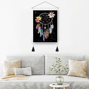 Bohemian dreamcatcher tapestry with floral patterns and tassels on a white wall