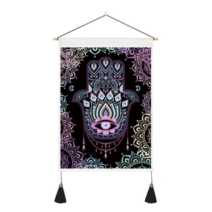 Macro shot of Hamsa hand tapestry with mandala patterns and black decorative tassels
