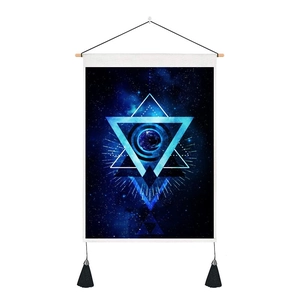 Close-up of sci-fi space wall hanging with geometric stars, moon, and black tassels