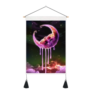 Detail of moon tapestry showing pink skull design, purple clouds and black tassels