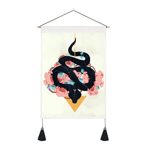 Macro view of floral snake tapestry showing fabric texture and black bottom tassels