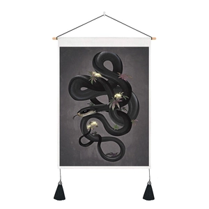 Detail of floral black snake tapestry with moon phase patterns and silk tassels on white