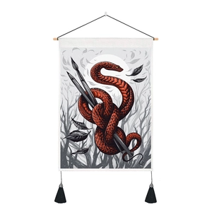 Detail of red snake and pencils on wall tapestry with wooden rod and black tassels