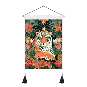 Detail of tiger tapestry with tropical flowers, wooden hanger, and black tassels