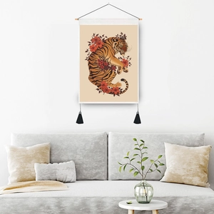 Tiger and floral print tapestry with wooden pole and tassels on a white living room wall