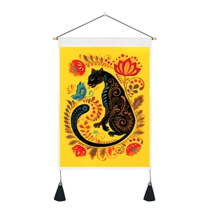 Detail of artistic black panther tapestry featuring floral patterns and wooden hanging pole