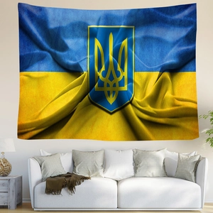 Ukraine national flag tapestry with golden trident crest hanging over a white sofa