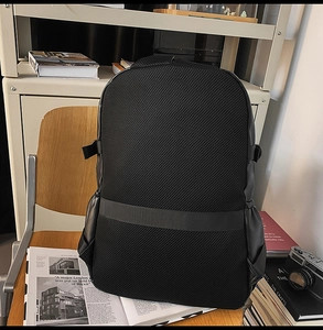 Detail of breathable mesh back panel and luggage strap on black laptop backpack
