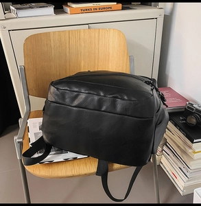 Detail of premium black leather laptop backpack with smooth zipper and durable straps