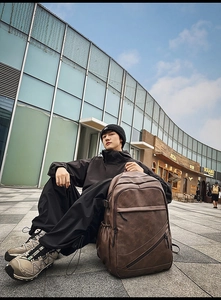 Brown vintage leather backpack featuring multiple zip pockets and large capacity design