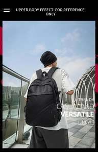 Male model wearing a large capacity black business backpack in an outdoor city setting