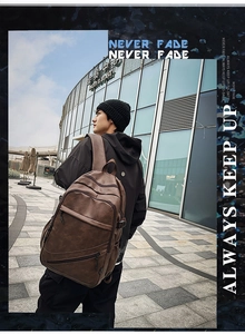 Deep brown vintage leather backpack shown on male model for business travel use