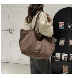 Detailed view of the leopard print canvas tote bag with 'our fave' patch on brown fabric