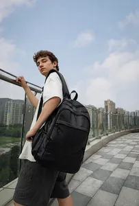 Men's large capacity black leather business backpack showing padded straps and multi-pockets
