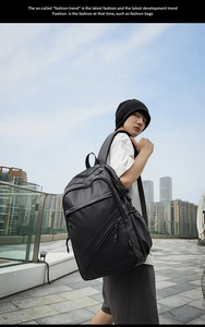 Side view of black business backpack with buckle straps and sleek waterproof matte finish