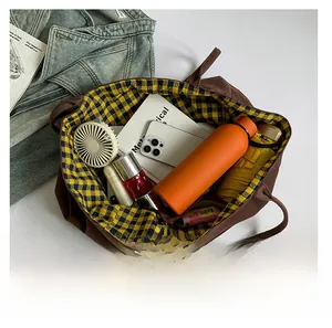 Detailed interior view of a large brown canvas tote bag showing its spacious capacity