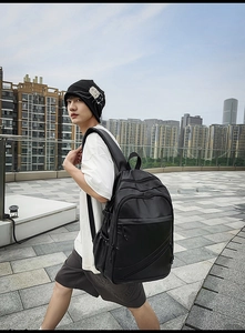 Detailed view of large black leather laptop backpack with ergonomic straps and urban style