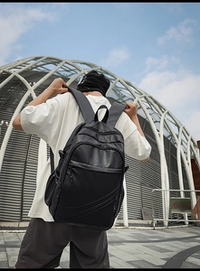 Detail of black faux leather business backpack with padded straps and matte finish