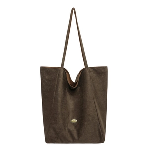 Brown suede tote bag for women featuring a minimalist handmade gold metal plaque detail