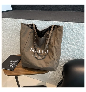Detailed view of brown tote bag with leopard print lining and Maliva printed text