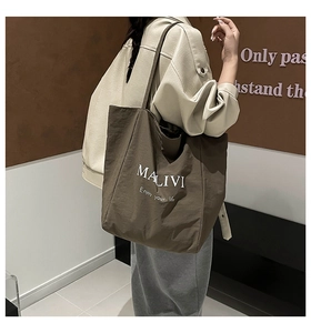 Detail of large brown leopard print canvas tote bag showing the MALIVI white logo text