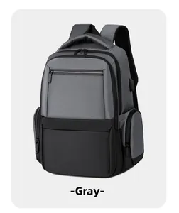 Detail of grey business backpack showing side-mounted USB charging port and fabric texture