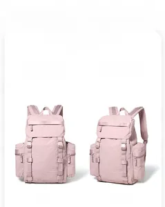Detail view of pink 25L outdoor hiking backpack with side pockets and buckle straps