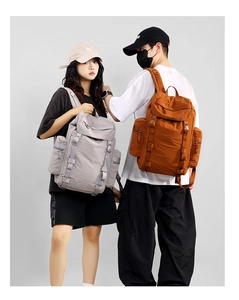 Detail view of large 25L outdoor hiking backpacks showing side pockets and gear attachment systems