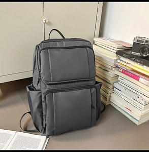 Detail of dark gray business backpack featuring high-density water-resistant fabric texture