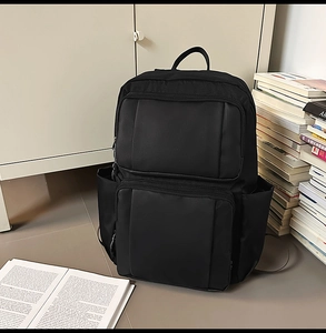 Detail view of large capacity black backpack with scratch-resistant nylon material
