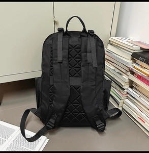 Detail of breathable padded back panel with diamond quilting on black business backpack