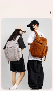 Outdoor 25L backpack in purple and caramel shown in a side view by models