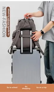Detail showing back sleeve of outdoor backpack fitting onto silver luggage handle