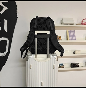 Detail of black business backpack with luggage strap and breathable quilted back panel