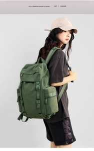 Detail view of olive green 25L hiking backpack featuring water-resistant fabric and side straps