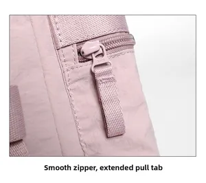 Detail of smooth SBS metal zipper with extended woven puller on the pink hiking backpack
