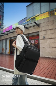 Outdoor shot of a multi-compartment black business laptop backpack for men with large capacity