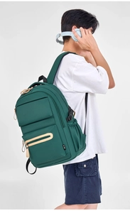 Side view of dark green nylon backpack featuring contrast zippers and mesh side pocket