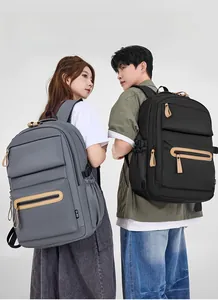 Rear view of grey and black nylon travel backpacks showing side buckles and water bottle mesh