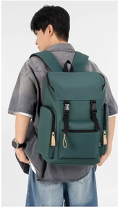 Detail view of large dark green nylon backpack showing buckle straps and side utility pockets