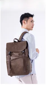 Detail of dark brown leather backpack with retro flap closure and buckle straps