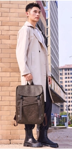 Outdoor shot of vintage coffee brown leather backpack with clbd side label detail