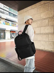 Outdoor view of large capacity black nylon business backpack with multi-layer zippers