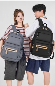 Close-up of nylon backpack with durable fabric texture and brown leather zipper pull details