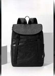 Close-up of black leather business backpack with side pocket and CLBD brand tag detail