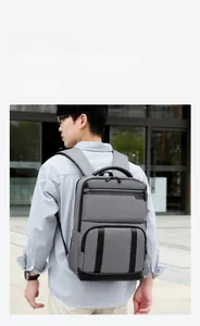 Deep grey expandable business travel backpack shown on person with urban style background